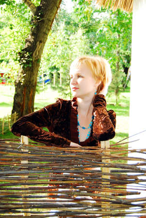 Young woman holding on fence.の写真素材