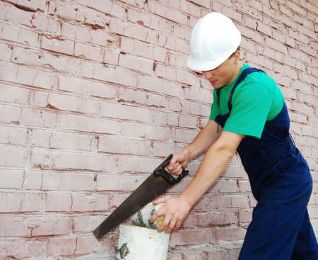 Muscular young man in a builder uniform.の写真素材