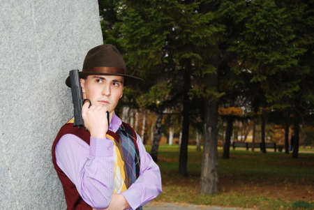 Dangerous looking mafia type with revolver.