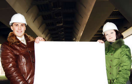 Young architects looking at blueprint.の写真素材