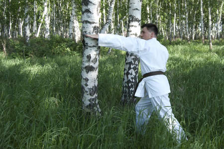 The karateka tries a kick in the field, open-airの写真素材