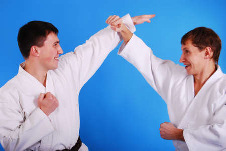 Two karatekas on a dark blue background.の写真素材