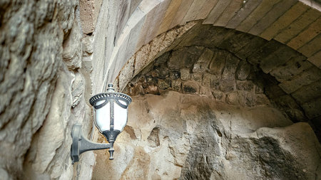 Cappadocia cave interior in Turkey with warm lantern lights and soft illumination highlighting stone walls and historic atmosphereの写真素材