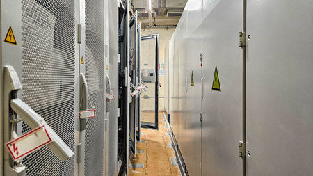 Modern server racks with network and power cables in a secure industrial data center environment