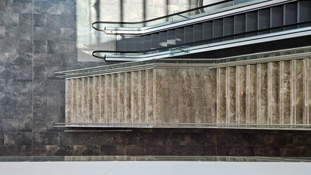Top view of modern marble stairs and escalator in bright contemporary interior. Clean geometry and...