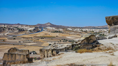 Wide Farmland And Scattered Rock Formations Under Clear Sky, Patchwork Fields And Distant...