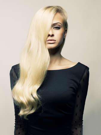 Photo of young beautiful lady with magnificent blond hairの写真素材