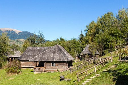 old wooden house in the Carpathian Mountains on a hillside in olruzhenii trees and grassのeditorial素材