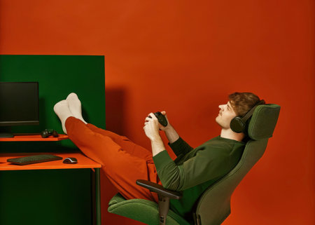 A young person is deeply engaged in a gaming activity within a stylish, modern home office setting, emphasizing relaxation and concentration. The image showcases a comfortable and inviting space.の素材