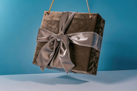 Gift box wrapped in brown paper and tied with a silk bowの素材