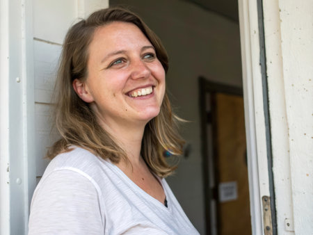 A beautiful woman with long, flowing hair smiles warmly, conveying happiness and positivity. The image captures a serene outdoor moment, highlighting her joyful expression and relaxed posture.の素材
