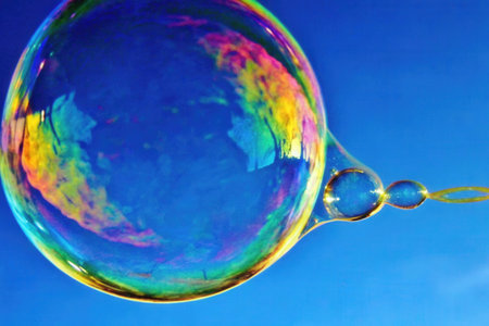 Soap bubbles against the blue sky, closeup of photo.の素材