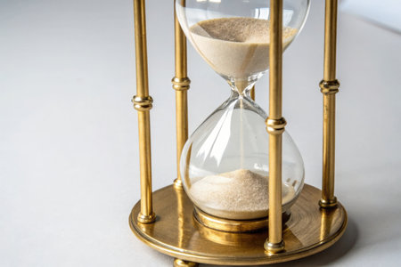 Hourglass with sand on a white background. Time passing concept.の素材