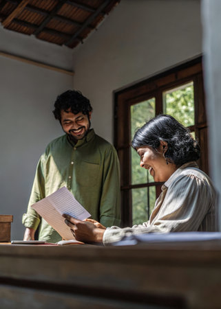 a man and woman are looking at a piece of paperの素材