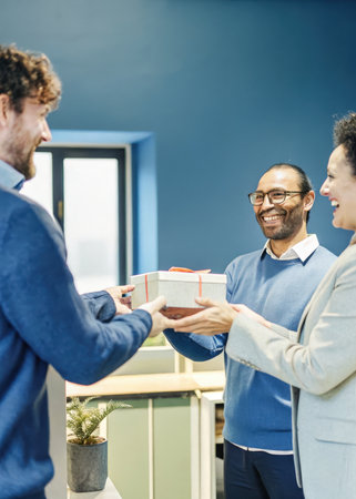 a man handing a woman a giftの素材