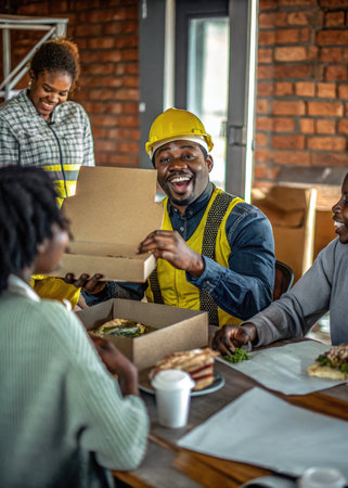 a group of people sitting around a table eatingの素材