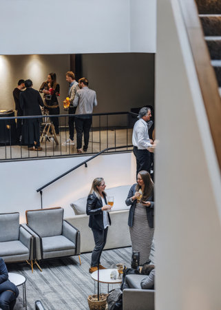 a group of people standing around a living roomの素材