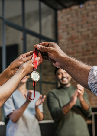 a man holding a medal in his handの素材