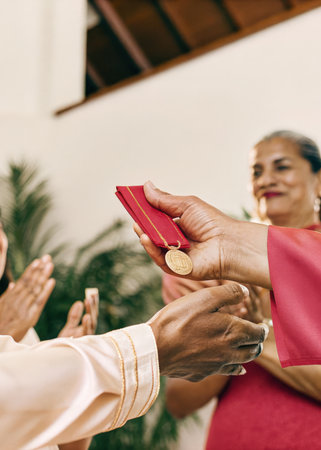 a man in a red shirt is giving a red cardの素材