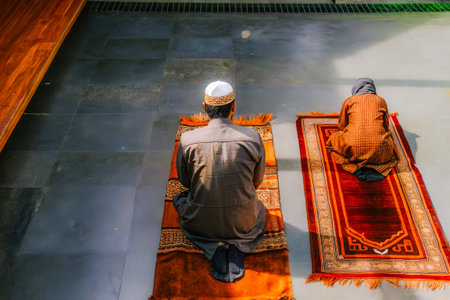 Muslim man praying in the prayer room at Masjid Jamek Mosque in Kuala Lumpur, Malaysiaの素材