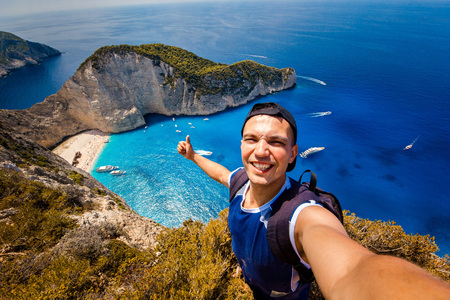 A guy doing selfie on a background of a shipwreck
