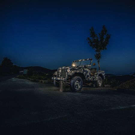 Khaki military offroad in the night on the island of Zakynthos, Greece