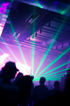 pink and green laser lights at disco clubの写真素材