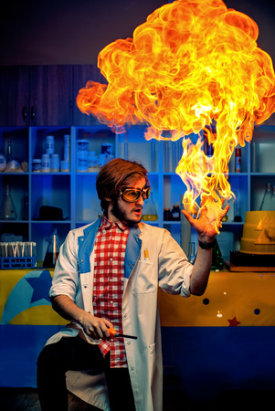 Excited scientist standing with burning arm in modern lab.