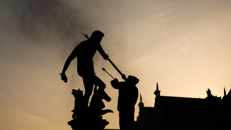 Silhouette of Neptune fountain in sunrise, Gdansk, Poland.の写真素材