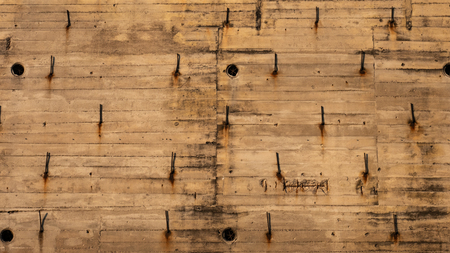 Old building with metal rods. Light brown background.の写真素材