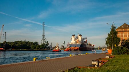 A big cargo ship moving on the Motlawa river in Gdansk.の写真素材