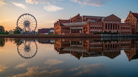 Ferris wheel, Gdansk sign and Baltic Philharmonic at sunrise.のeditorial素材