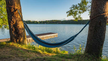 A pier over the Masurian lake and a hammockの写真素材