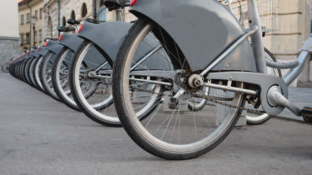 Electric bikes arranged neatly in stands.の写真素材