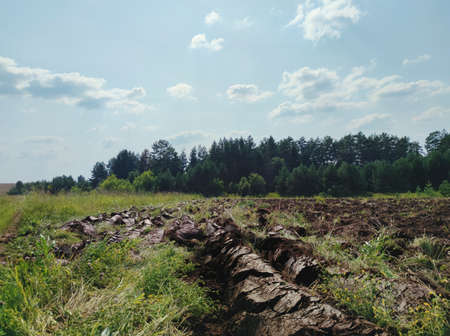 plowed field against the blue sky on a sunny day