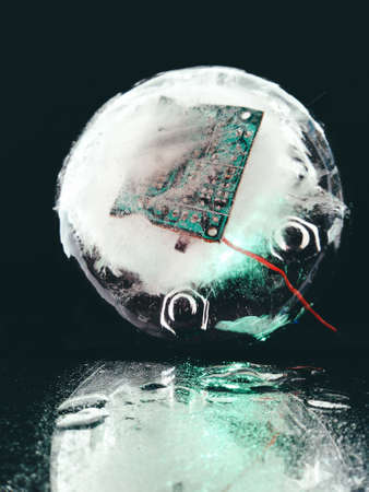abstract photo with electrical circuit frozen in ice in the dark