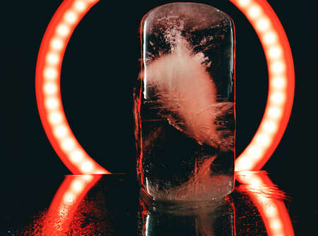 abstract photo of ice illuminated by red light in darknessの写真素材