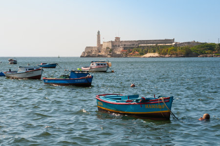 Fishing boats anchored at the entrance to the havana bay with the morro lighthouse in the background. Havana Cuba. May 11, 2015のeditorial素材