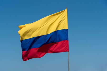 Colombia flag with blue backgroundの写真素材