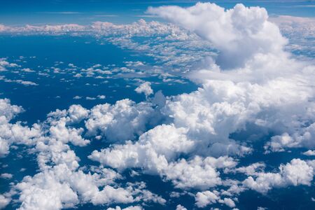 aerial view of clouds blue sky envelopes in a flight over colombiaの写真素材