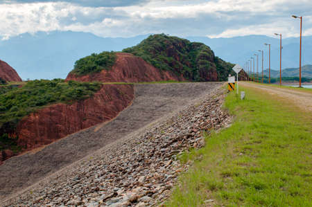 Dirt road with lighting between mountain landscape. Colombiaの写真素材