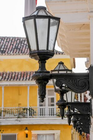 Colonial style street lamp with background with balconies in the streets of Cartagena. Colombiaの写真素材