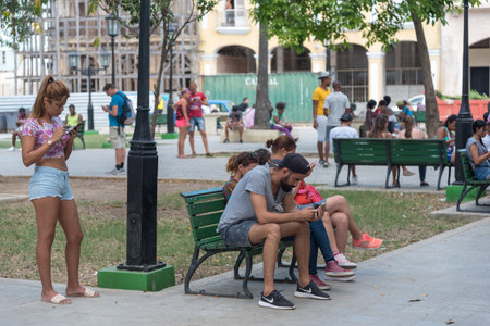 Park where people of all ages meet to find wi fi in the old havana. Havana Cuba. January 2, 2019.のeditorial素材