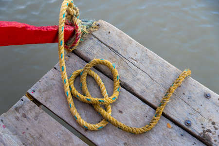 Rope moored from a small pier in a Colombian riverの写真素材