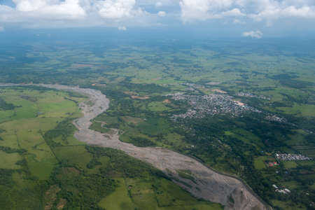 Aerial view of the river with little water, with a nearby town and agricultural crops around. Department of Córdoba Colombiaの写真素材