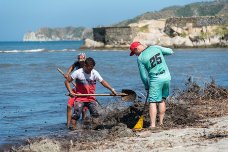 Workers working on cleaning a beach in Santa Marta. Magdalena department. Colombia. November 8, 2019.のeditorial素材