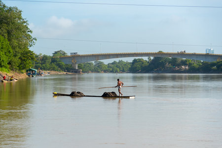 Worker collecting manual sand by boat in the Sinu River. a way of life of some inhabitants of the region. Hunting. Cordova. Colombia. December 13, 2019.のeditorial素材