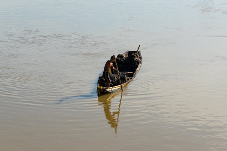 Worker collecting manual sand by boat in the Sinu River. a way of life of some inhabitants of the region. Hunting. Cordova. Colombia. December 13, 2019.のeditorial素材