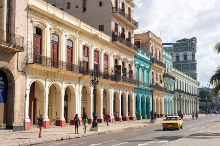 Avenue with colorful colonial facades in old Havana with the movement of people in daily activity. Havana. Cuba.January 10, 2020.のeditorial素材