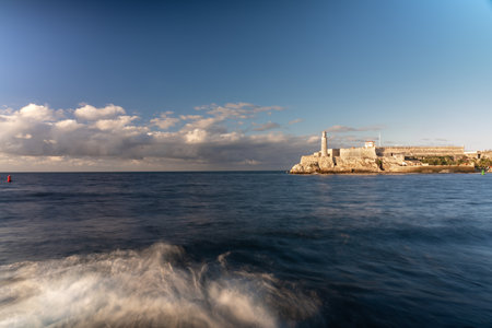 Low exposure photo of the Malecon in Havana with the Morro lighthouse in the evening light. Havana. Cuba. January 6, 2020.のeditorial素材